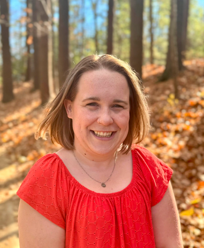 woman wearing red blouse and smiling
